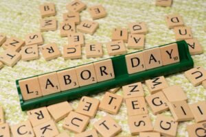 a labor day sign with scrabble letters